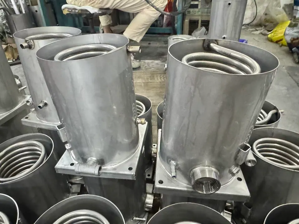 Stainless helical coils installed inside cylindrical stainless vessels during fabrication